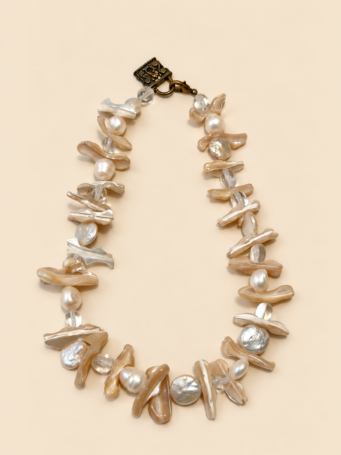 Pearl and shell necklace laid flat, full length