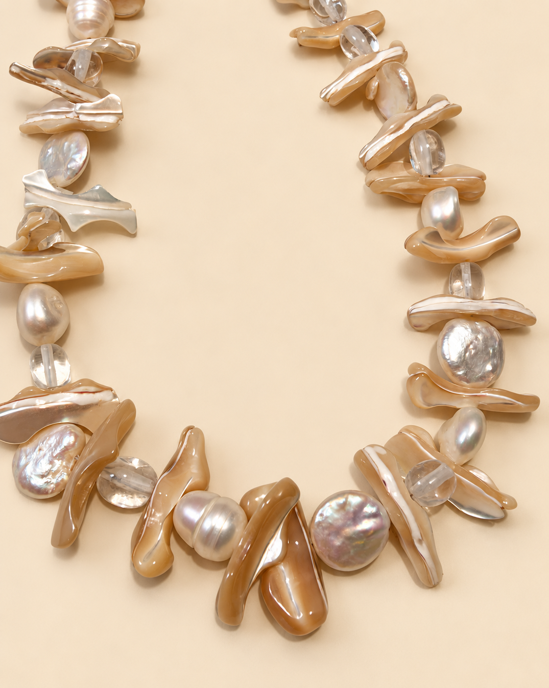 Close-up of freshwater pearls, mother-of-pearl petals and clear crystal beads