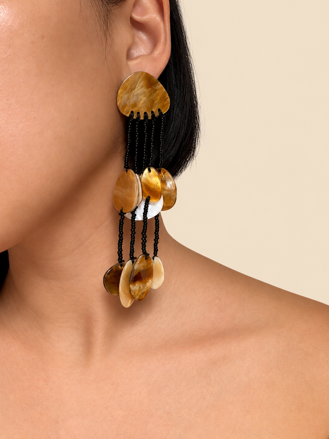 Shell drop earring worn on the ear