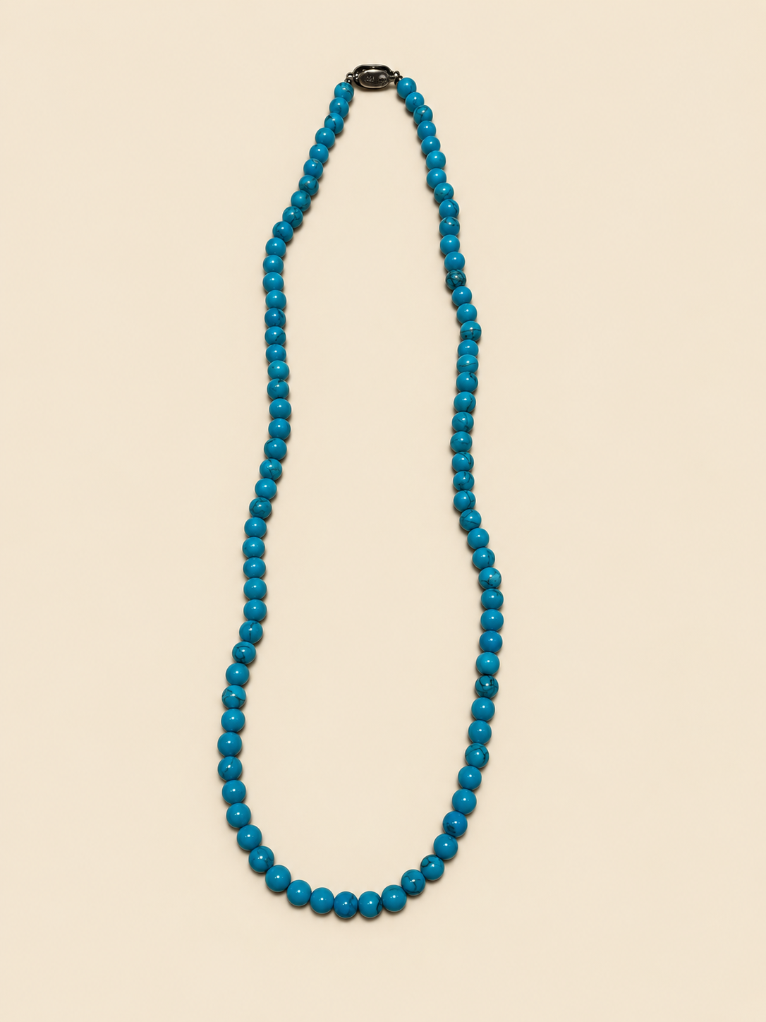 Turquoise bead necklace laid flat, full length